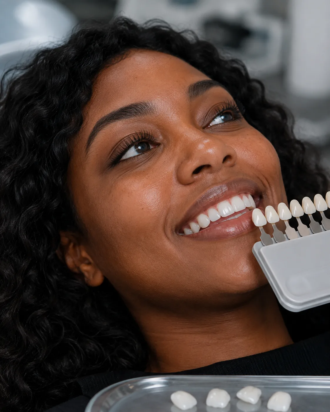 Patient smiling during a cosmetic dentistry shade consultation at Plaza Dental Arts
