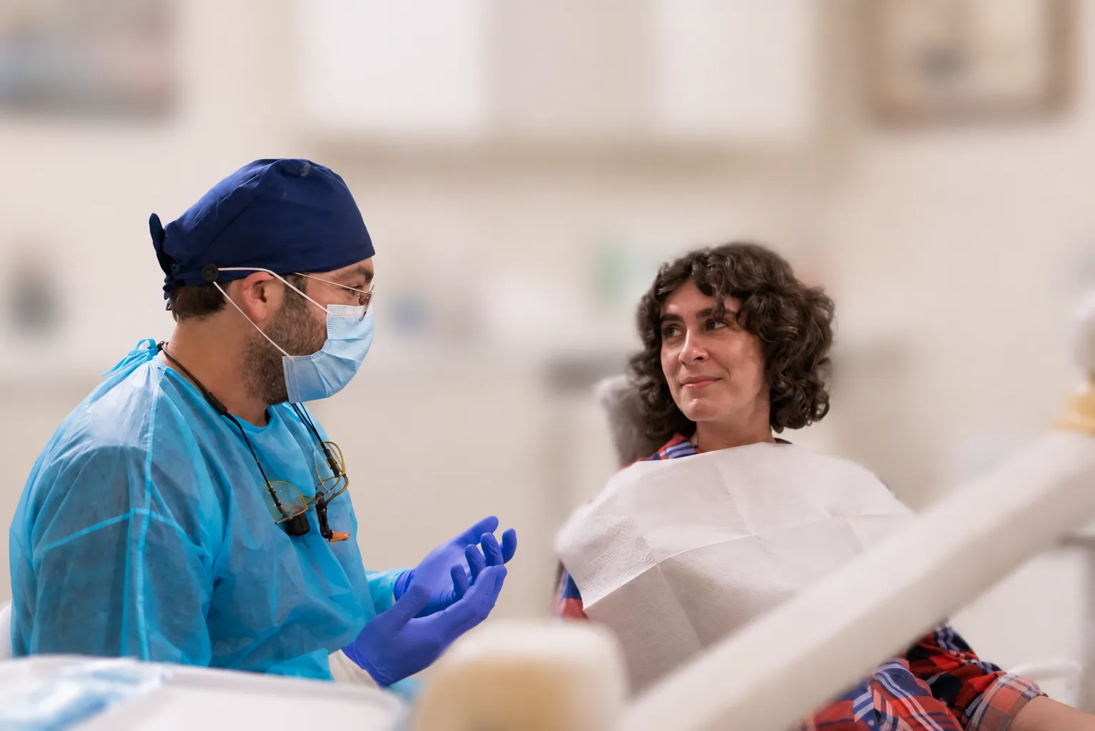 Dentist speaking with a patient during a visit